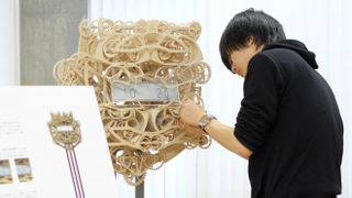 Illustration for article titled This Impossibly Complicated Mechanical Clock Re-Writes the Time Every Minute
